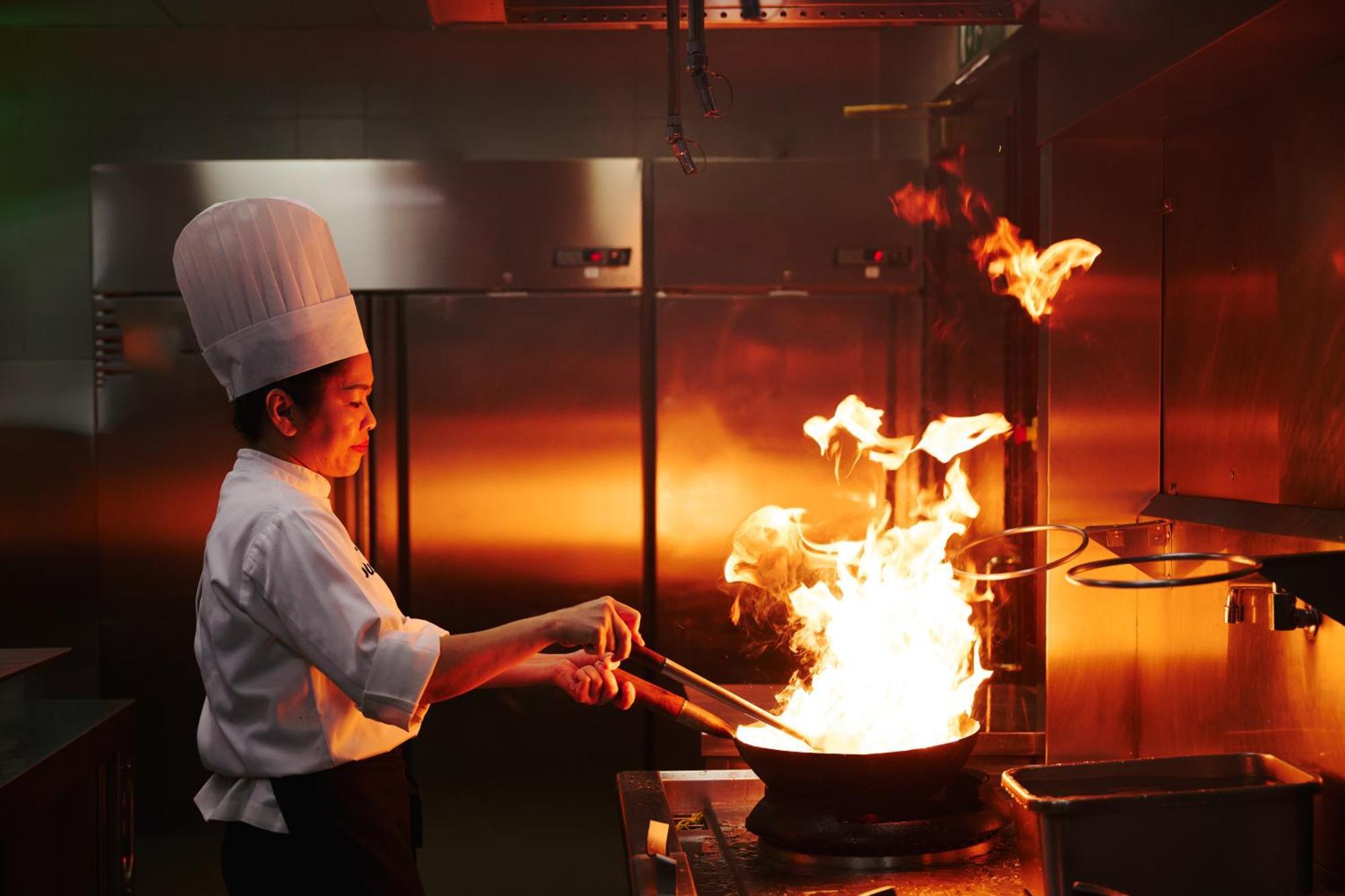 Dusit Doha Hotel Εξωτερικό φωτογραφία A chef cooking with a wok